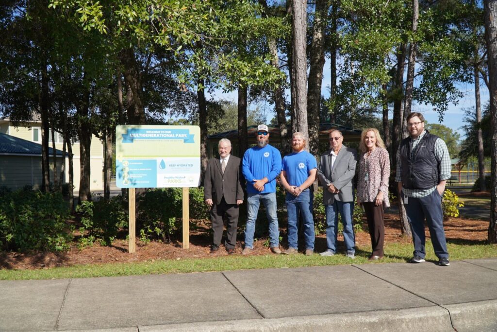 Staff photo with Multigenerational park sign